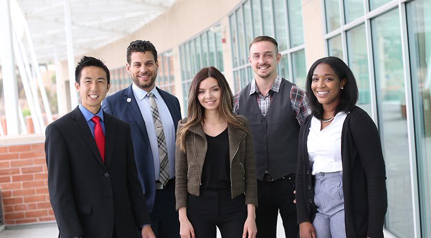 Group of give students in front of the Golden Eagle building